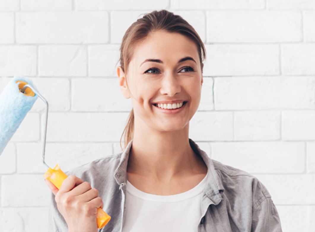 young-woman-holding-paint-roller-for-renovation-at-YVK8WJV.jpg